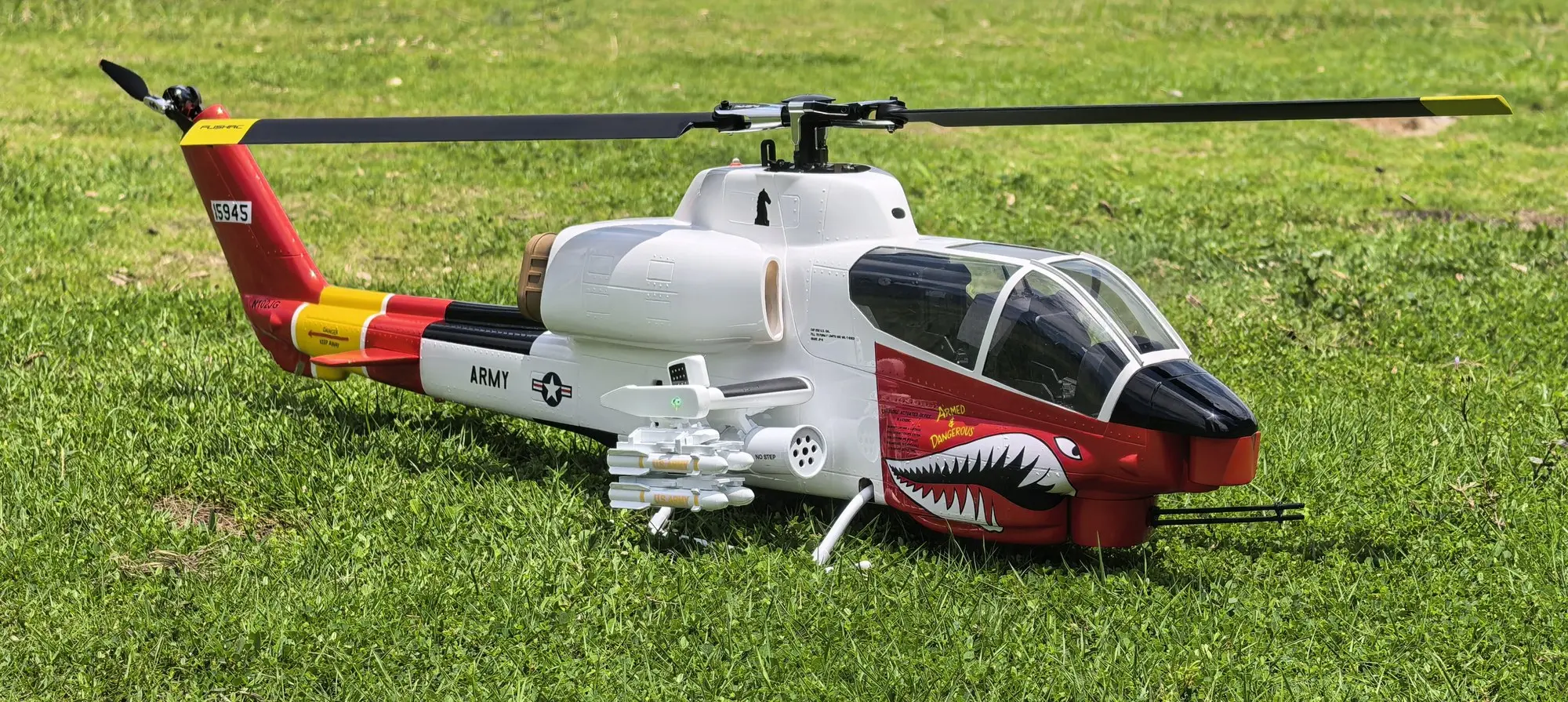 FLISHRC AH-1 Cobra white and red RC helicopter rear three-quarter view showing tail boom and rotor